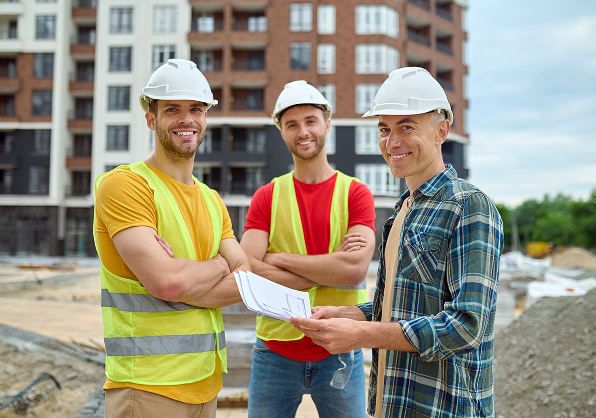 engineer-with-drawing-two-workers-construction-site-rid1